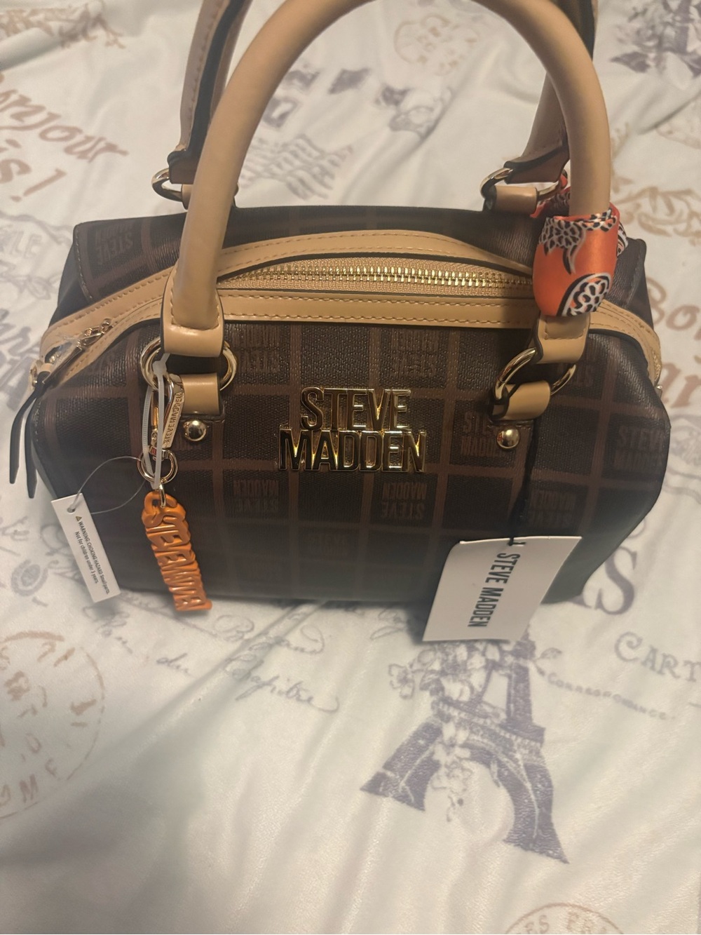 Steve Madden Brown Monogram Satchel with Tan Trim and Orange Charm